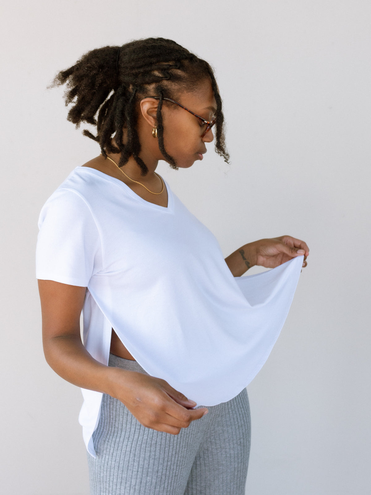 Modern white tee with side opening nursing access for a built-in breastfeeding cover.
