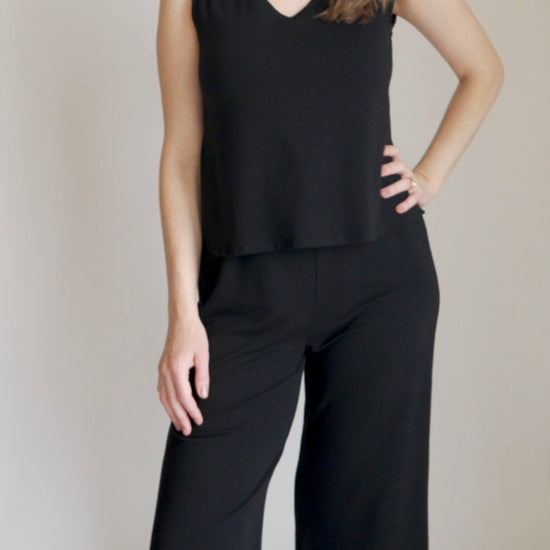 woman showing nursing function on black jumpsuit